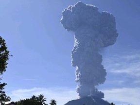 In this photo released by the Vulcanology and Geological Disaster Mitigation Center of the Indonesian Ministry of Energy and Mineral Resources (PVMBG-ESDM), Mount Ibu spews volcanic materials into the air during an eruption in West Halmahera, Indonesia, Monday, May 13, 2024.