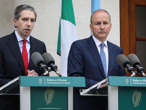 Ireland's Prime Minister Simon Harris (L), flanked by Ireland's Minister of Foreign Affairs Michel Martin (R), delivers a speech during a press conference, to recognise the state of Palestine at the Government buildings, in Dublin, on May 22, 2024. Ireland will recognise a Palestinian state, its Prime Minister Simon Harris said on May 22, 2024, in a joint announcement with Oslo and Madrid. "Today, Ireland, Norway and Spain are announcing that we recognise the state of Palestine," Harris said outside government buildings in Dublin. (Photo by Paul FAITH / AFP)