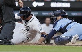 Tigers' Carson Kelly is tagged out by Blue Jays catcher Danny Jansen while trying to score on a single in the sixth inning at Comerica Park on May 23, 2024 in Detroit.