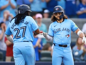 Blue Jays' Bo Bichette (right) celebrates with Vladimir Guerrero Jr. after hitting a two-run home run in the second inning against the Chicago White Sox at Rogers Centre on May 22, 2024 in Toronto.