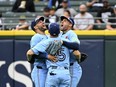 From left, Blue Jays outfielders Kevin Kiermaier, Daulton Varsho and George Springer celebrate their team win over the Chicago White Sox at Guaranteed Rate Field on May 27, 2024 in Chicago.