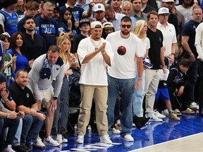 Patrick Mahomes and Travis Kelce of the Kansas City Chiefs look on during the fourth quarter of Game 3 of the Western Conference Finals between the Dallas Mavericks and the Minnesota Timberwolves at American Airlines Center on May 26, 2024 in Dallas.