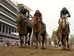 Brian Hernandez Jr. rides Mystik Dan, right, to the finish line to win the 150th running of the Kentucky Derby horse race at Churchill Downs Saturday, May 4, 2024, in Louisville, Ky.
