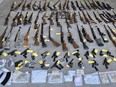 Lennox and Addington County OPP seized almost 100 guns and drugs in a search of a residence in Tyendinaga Township on Friday, May 24, 2024.
