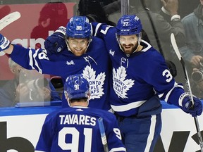 Toronto Maple Leafs' William Nylander (88) celebrates his goal against the Boston Bruins with John Tavares (91) and Timothy Liljegren (37) during the second period of Game 6 in Toronto on Thursday, May 2, 2024.
