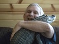 Joie Henney hugs his emotional support alligator named Wally, Jan. 22, 2019, inside their home in York Haven, Pa.