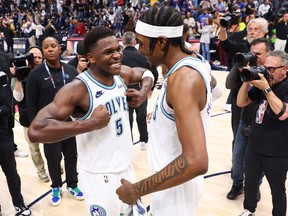 Anthony Edwards (left) and Jaden McDaniels of the Minnesota Timberwolves celebrate after winning Game 7 against the Denver Nuggets at Ball Arena on May 19, 2024 in Denver.