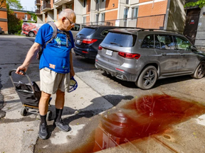 Mohammad Mobed walks past a puddle stained with the blood of stabbing victims next to the building where he lives in Montreal on May 22, 2024. Three people died, including a 15-year-old boy.