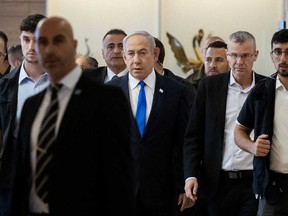 Israeli Prime Minister Benjamin Netanyahu (centre) arrives for a party meeting at the Israeli parliament, the Knesset, in Jerusalem on May 20, 2024.
