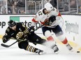 Brad Marchand of the Boston Bruins battles for the puck against Brandon Montour