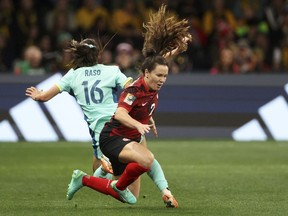 Canada's Allysha Chapman and Australia's Hayley Raso, left, fall to the ground during the Women's World Cup Group B soccer match between Australia and Canada in Melbourne, Australia, Monday, July 31, 2023. Canada coach Bev Priestman is starting to get some of her injured talent back ahead of the Paris Olympics.