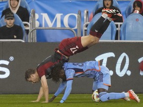 Toronto FC defender Sigurd Rosted (17) falls over New York City forward Malachi Jones (88) during first half MLS action in Toronto, Saturday, May 11, 2024.