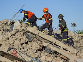 Rescue personnel search the site of a building collapse in George, South Africa, Thursday, May 9, 2024. Rescue teams searching for dozens of construction workers missing after a multi-story apartment complex collapsed in the coastal city have not brought out more survivors in the past 24 hours.