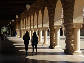Students walk on the Stanford University campus on March 14, 2019, in Stanford, Calif.
