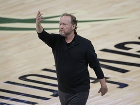 Milwaukee Bucks coach Mike Budenholzer directs the team during the first half against the Phoenix Suns in Game 4 of basketball's NBA Finals on July 14, 2021, in Milwaukee.