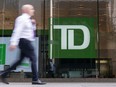 A person makes their way past a Toronto-Dominion Bank in the Financial District of Toronto on Aug. 14, 2023.