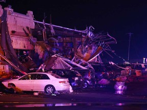 Several cars are seen heavily damaged outside the remains of a Shell gas station after a suspected tornado, Sunday, May 26, 2024, in Valley View, Texas.