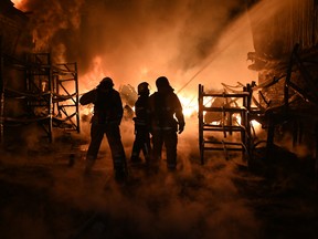 Ukrainian firefighters work to extinguish a fire