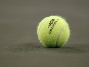 FILE - A tennis ball on the court during the first round of the U.S. Open tennis tournament in New York, Tuesday, Aug. 30, 2011. A tennis player has been awarded $9 million in damages by a jury in federal court in Florida after accusing the U.S. Tennis Association of failing to protect her from a coach she said sexually abused her at one of its training centers when she was 19.