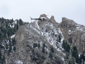 A Utah Department of Public Safety helicopter carries rescuers from Hidden Valley Park on Thursday, May 9, 2024, Thursday, May 9, 2024, in Sandy, Utah.
