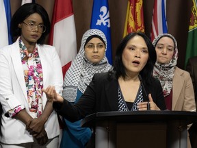 Sudanese Canadian Einam Mohammadian (left), Palestinian Canadian Israa Alsaafin (second left) and Safinaz El-Sohl (right) look on as NDP MP for Vancouver East Jenny Kwan (front) speaks during a news conference, Wednesday, May 22, 2024 in Ottawa.