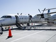 WestJet Airlines has plans to soon introduce a new cheaper fare category that would be available to travellers willing to fly without a carry-on bag. A passenger boards a WestJet Encore Bombardier Q400 twin-engined turboprop aircraft in Kamloops, B.C., Saturday, June 3, 2023.