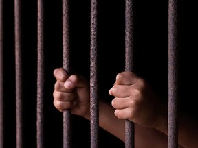 Man in a jail cell.