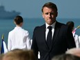 France's President Emmanuel Macron walks to the podium to deliver a speech during the International commemorative ceremony at Omaha Beach marking the 80th anniversary of the World War II "D-Day" Allied landings in Normandy.