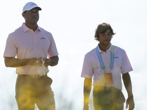 Tiger Woods and son Charlie Woods walk to the third green during a practice round prior to the U.S. Open.