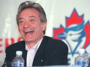 Paul Godfrey laughs during a press conference.