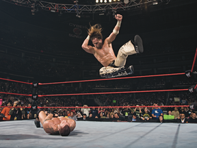 WWE wrestler Shawn Michaels delivers a flying elbow drop.