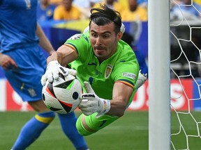 Romania's goalkeeper Florin Nita dives to save a ball during the UEFA Euro 2024 Group E football match between Romania and Ukraine.
