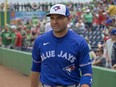 Toronto Blue Jays’ Joey Votto walks to the dugout before a spring training baseball game against the Philadelphia Phillies.