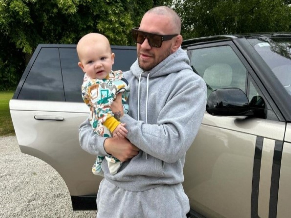 UFC fighter Conor McGregor holds his child.