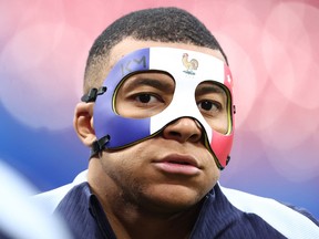 France's Kylian Mbappe wears a face mask as he takes part in a training session at the Leipzig Stadium.