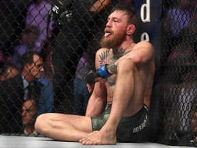 Conor McGregor of Ireland is sits on the mat in the octagon after being defeated by Khabib Nurmagomedov.