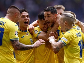 Ukraine forward Roman Yaremchuk (2nd R) celebrates scoring his team's second goal with his teammates against Slovakia.