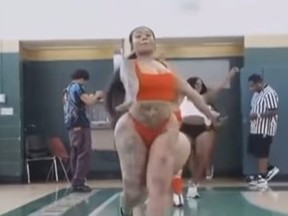 A woman dances during an ad to promote a basketball tournament.