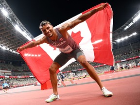 Andre De Grasse of Team Canada celebrates after winning the bronze medal in the Men's 100m Final on day nine of the Tokyo 2020 Olympic Games at Olympic Stadium.