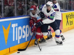 Norway's Stian Solberg, right, challenges Denmark's Frederik Storm during the preliminary round match at the Ice Hockey World Championships.