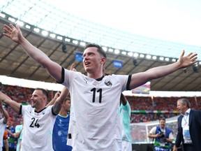Michael Gregoritsch of Austria celebrates after the team's victory and qualification to the knockout stages at Euro 2024.