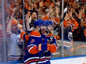 The Edmonton Oilers' Evan Bouchard (2) and Connor McDavid (97) celebrate Bouchard's goal against the Dallas Stars during first period NHL playoff action at Rogers Place, in Edmonton Wednesday May 29, 2024.
