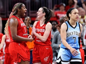 Chennedy Carter #7 walks past Aliyah Boston #7 and Caitlin Clark #22 of the Indiana Fever as they celebrate defeating her Chicago Sky in the game at Gainbridge Fieldhouse on June 1, 2024 in Indianapolis, Indiana.