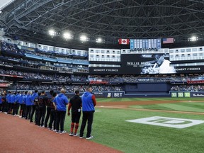Members of the Toronto Blue Jays stand for a moment of silence to honour baseball great Willie Mays.