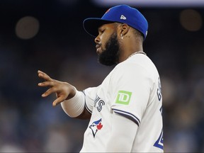 Vladimir Guerrero Jr. of the Toronto Blue Jays looks at his hand.