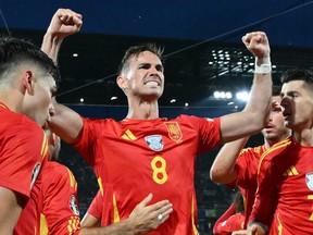 Spain's midfielder Fabian Ruiz celebrates with teammates after a goal.