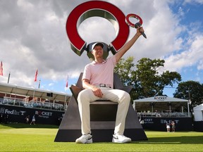 Cameron Davis of Australia celebrates with the trophy after winning during the final round of the Rocket Mortgage Classic.