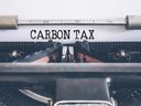 Close-up of words CARBON TAX written on vintage typewrite.