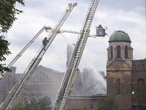 Firefighters work to put out a blaze at St. Anne’s Anglican Church.