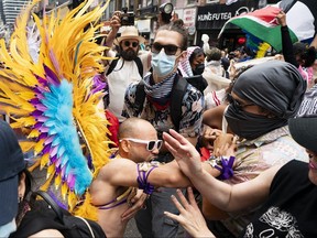 A pride marcher clashes with pro-Palestinian protesters.